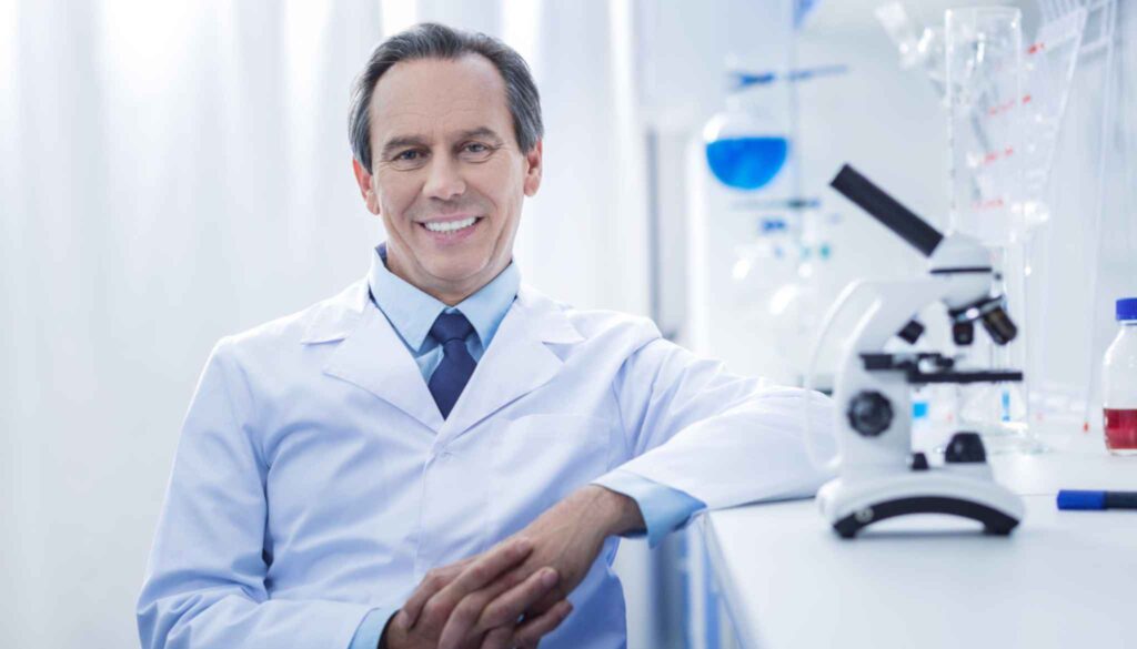 Lab manager is sitting beside a lab machine