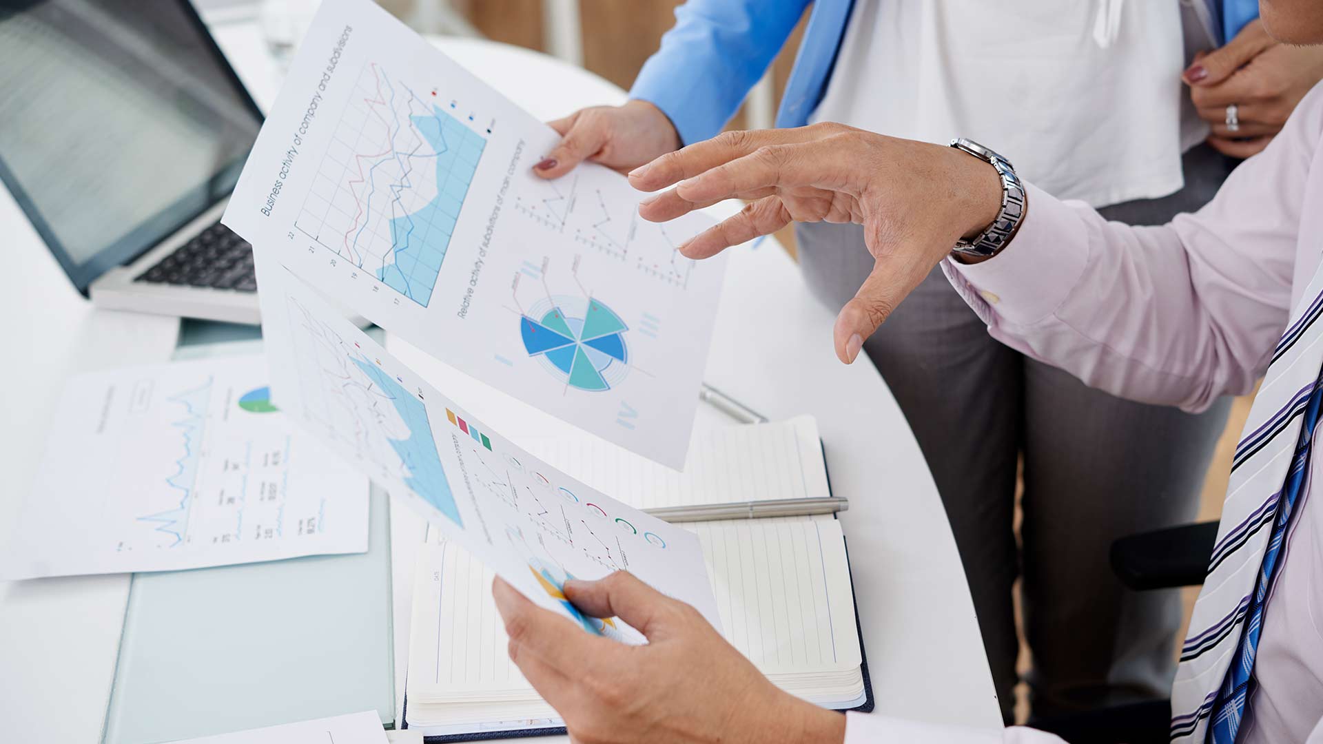 Team reviewing business analytics and safety metrics while implementing a health and safety management system during rapid organizational growth.